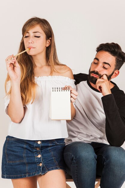 Young couple with notepad