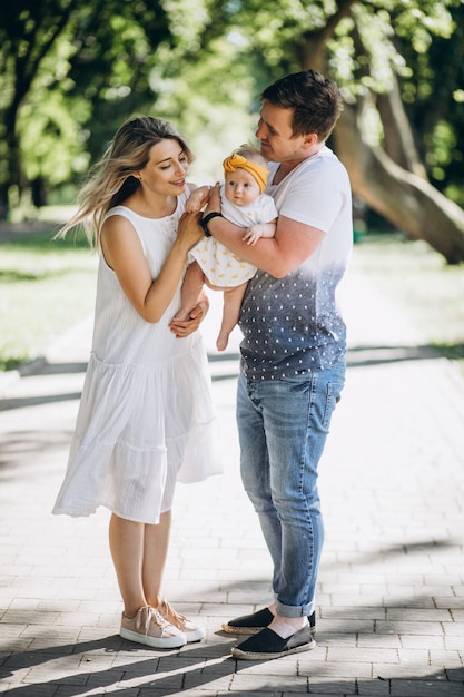 Young couple with their baby daughter in park