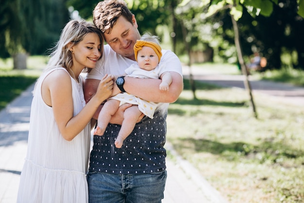 Young couple with their baby daughter in park