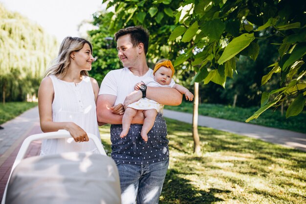 Young couple with their baby daughter in park