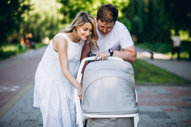 Young couple with their baby daughter in park