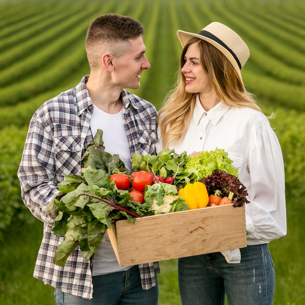 Free photo young couple with vegetables basket