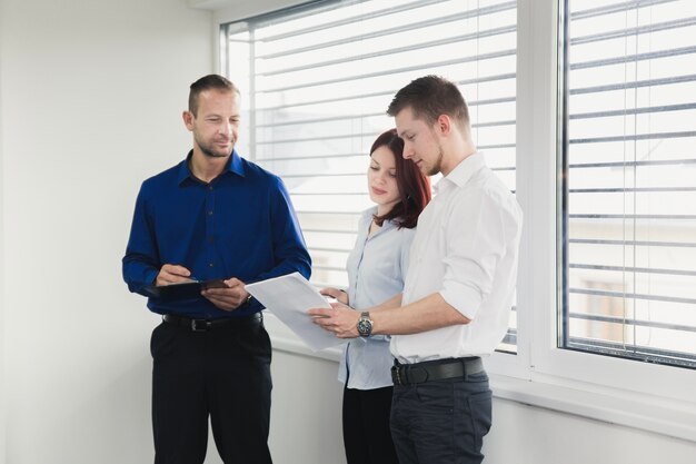 Young coworkers discussing documents