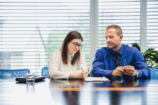 Young coworkers with documents at table