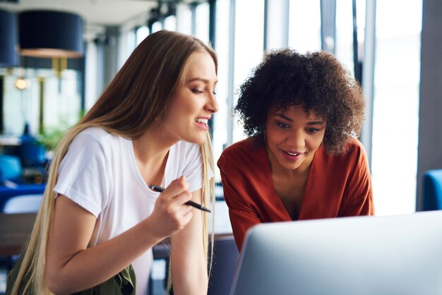 Young coworkers working on computer