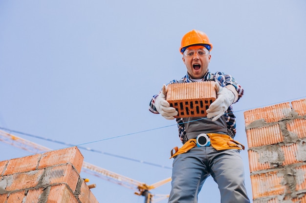 Free photo young craftsman building a house