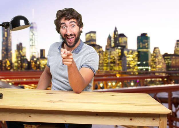 young crazy man on a table surprised expression