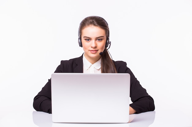 Young customer service girl with a headset at her workplace isolated on white wall