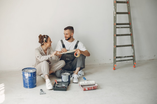 The young and cute couple repairs the room