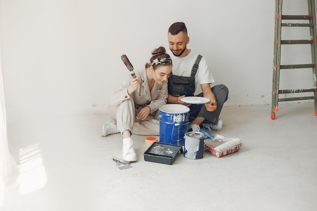 The young and cute couple repairs the room