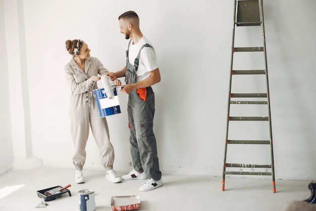 The young and cute couple repairs the room