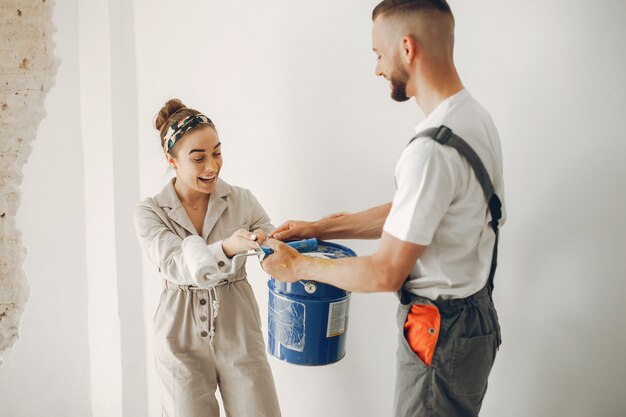 The young and cute couple repairs the room