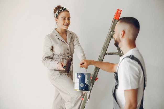 The young and cute couple repairs the room