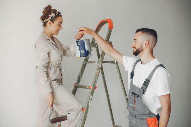 The young and cute couple repairs the room