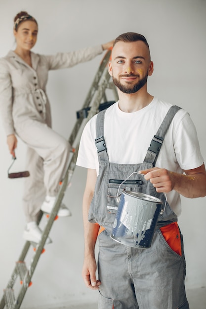 The young and cute couple repairs the room