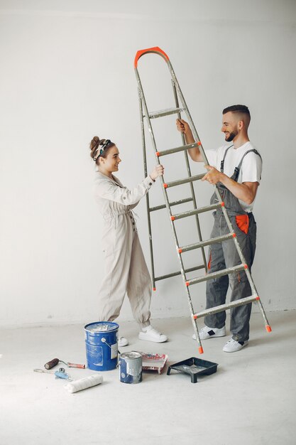 The young and cute couple repairs the room