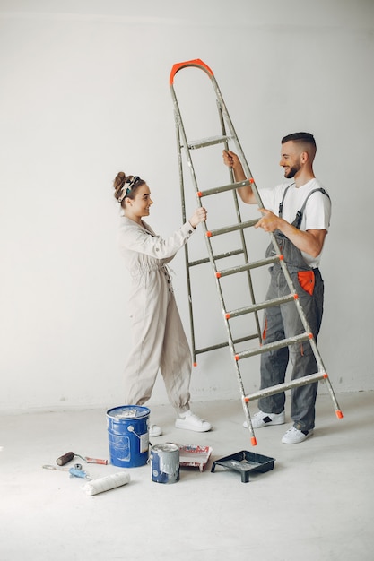 The young and cute couple repairs the room