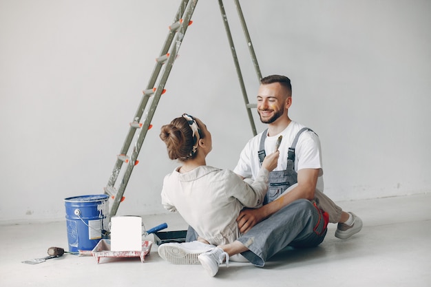 The young and cute couple repairs the room