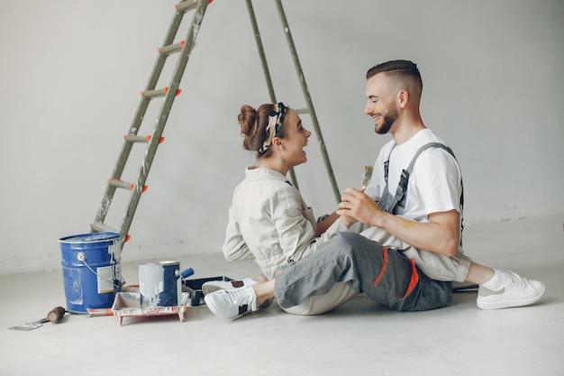 The young and cute couple repairs the room