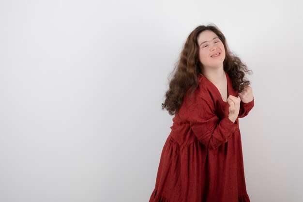 young cute girl with down syndrome standing and posing .