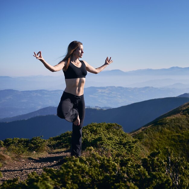 Young cute woman meditating on fresh air