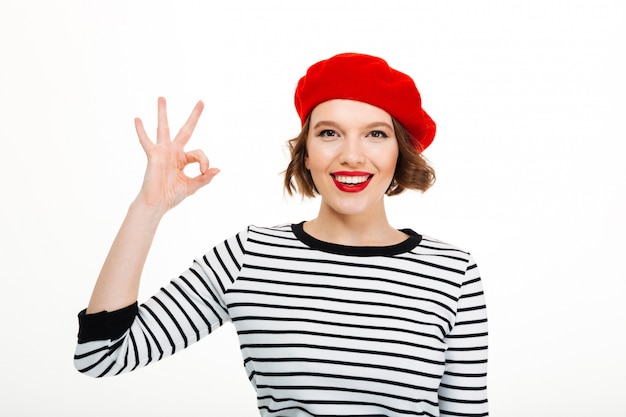 Young cute woman showing okay gesture.