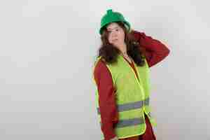 Free photo young cute woman with down syndrome standing in vest and holding crash helmets .