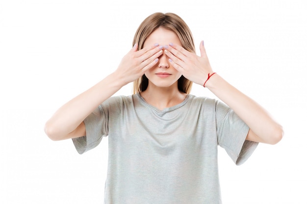 Young cute young woman covering eyes with two hands