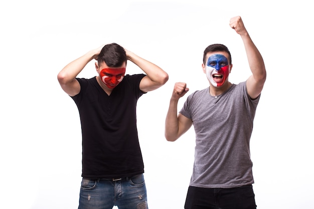 Young czech and tunisian football fans win and lose emotions isolated on white wall