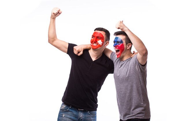 Young czech and tunisian football fans win and lose emotions isolated on white wall