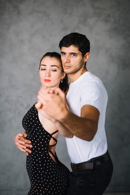 Young dance partners dancing tango