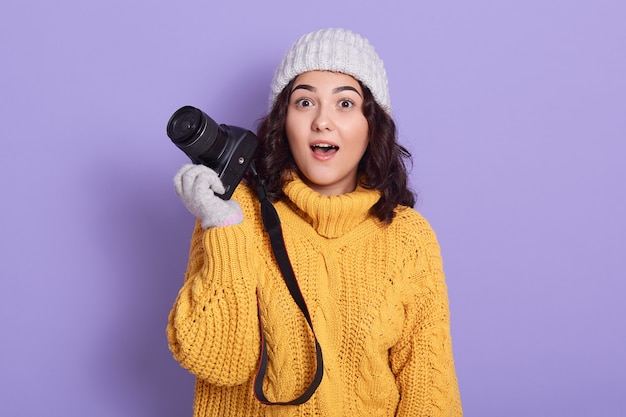 Young dark haired photographer being shocked about photo she made