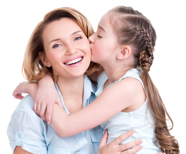 Young daughter  kissing mother - isolated