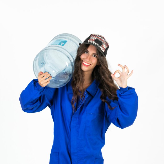 Young deliverywoman with water carafe