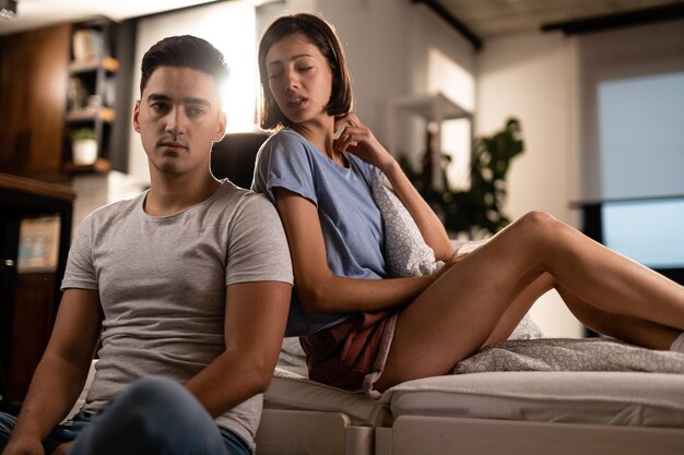 Young displeased couple having relationship problems in the bedroom