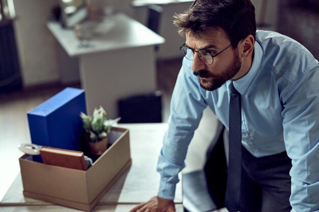 Young distraught businessman thinking after getting fired from his job