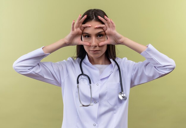 Молодой доктор девушка носить медицинский халат стетоскоп - на зеленой стене 7