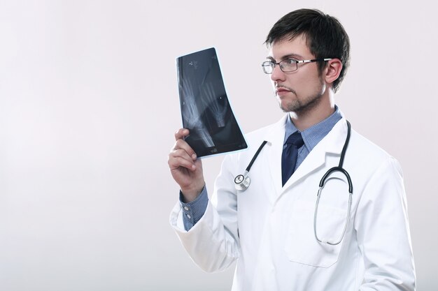 Young doctor looking at x-ray image