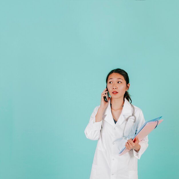 Young doctor speaking on phone