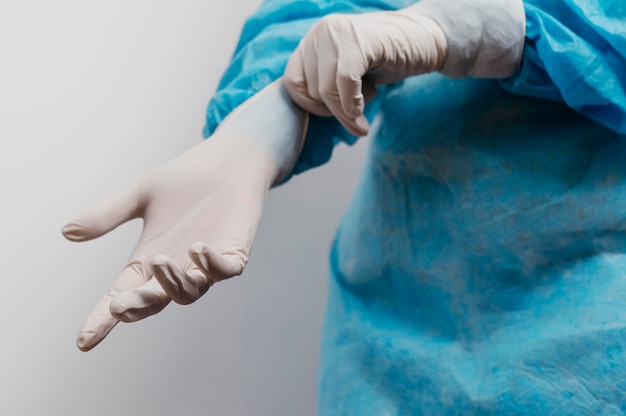 Young doctor wearing surgical gloves