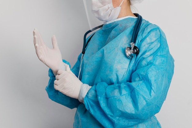 Free photo young doctor wearing surgical gloves