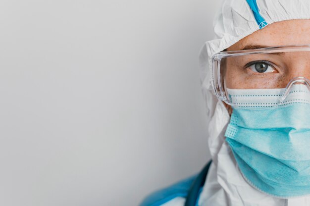 Young doctor with protective equipment with copy space
