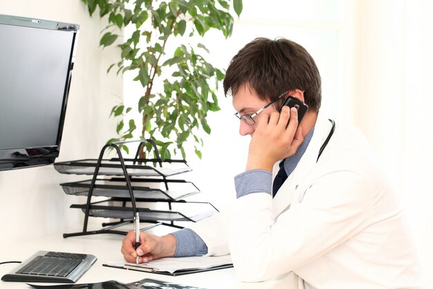 Young doctor working in his office