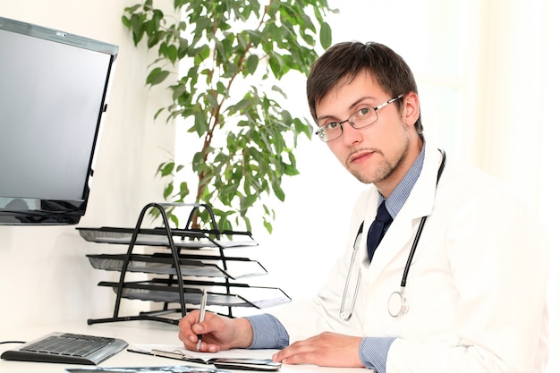 Young doctor working in his office