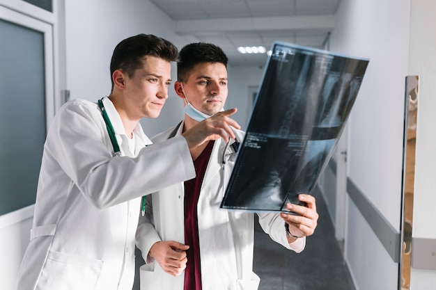 Young doctors pointing at x-ray shot