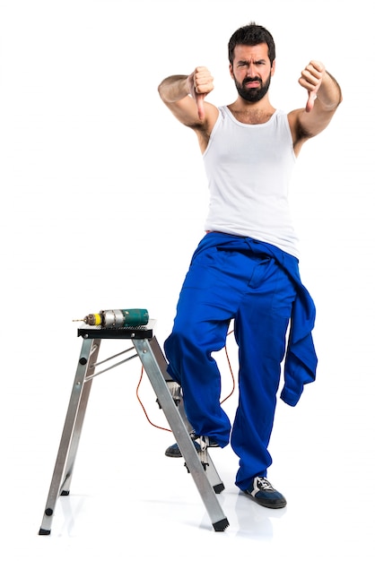 Young electrical technician with a drill doing bad signal