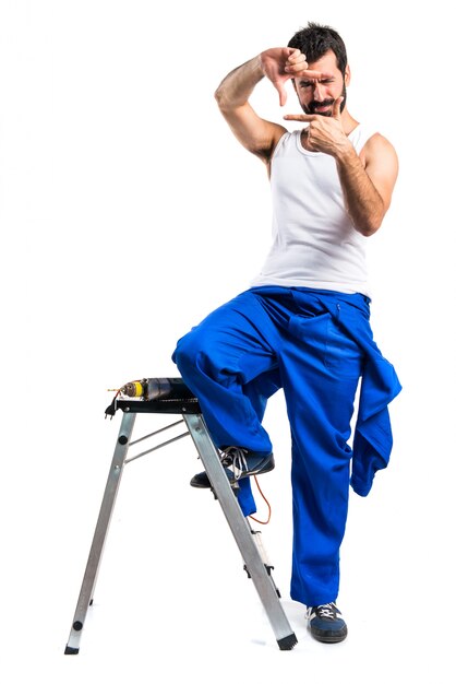 Young electrical technician with a drill focusing with his fingers