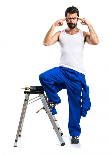 Young electrical technician with a drill thinking