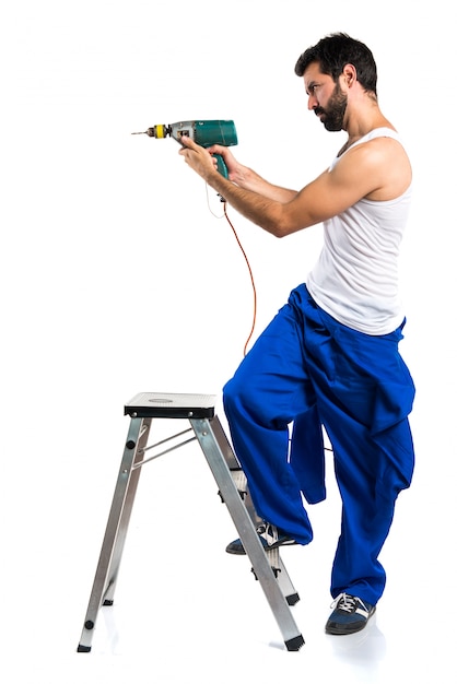 Young electrical technician with a drill