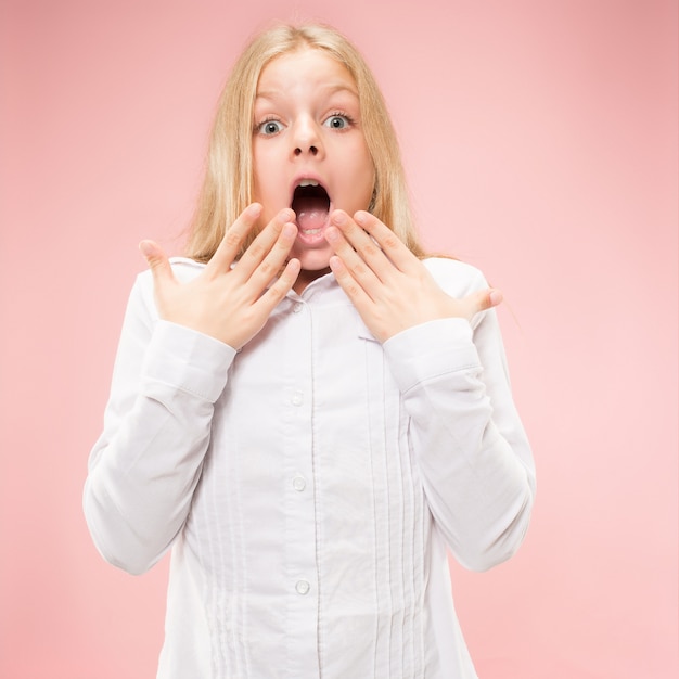 Free photo young emotional surprised teen girl standing with open mouth